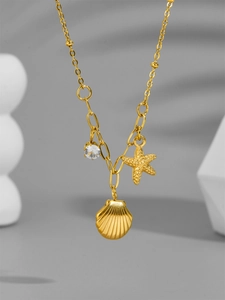 Detail of 18k gold plated starfish and shell pendants with sparkling zircon stone
