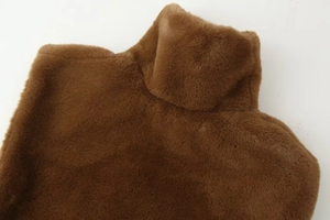 Detail view of brown faux fur texture and high collar stand on a cozy winter shawl