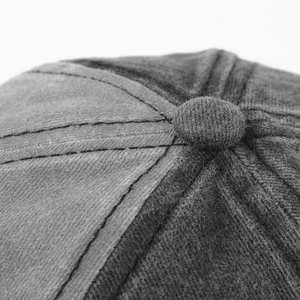 Macro shot of high-quality stitching and top button on a washed cotton baseball cap