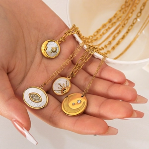 Golden celestial sun moon necklaces with mother of pearl and crystal charms