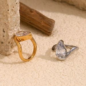 Waterdrop-cut pear zirconia rings in 18K gold and silver plating on a stone base