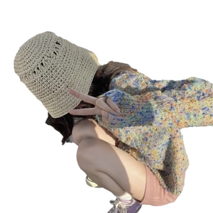 Foldable beige straw bucket hat for women providing stylish outdoor sun protection