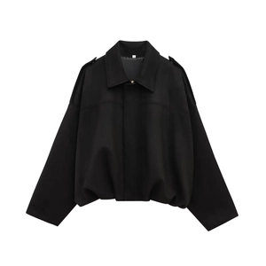 Detail of black bomber jacket featuring epaulettes, oversized batwing sleeves and hem.