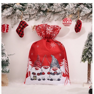Close-up of Christmas gnome drawstring gift bag with snow patterns and festive decor