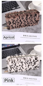 Macro shot of fluffy leopard print plush pouches in apricot and pink with gold zippers