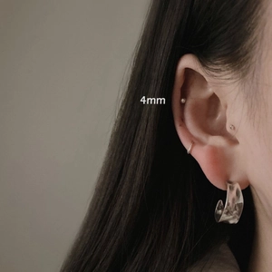 Minimalist 925 sterling silver C-shaped hoop earrings with hammered texture on model