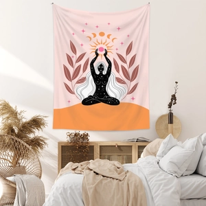 Detail of bohemian tapestry featuring a meditating woman silhouette under sun and moon symbols