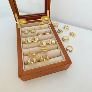 Detailed view of 18k gold plated copper rings with zircon teardrop and heart shapes