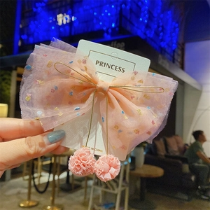 Pink tulle bow hair clip with sequins and pompoms for girls on card display