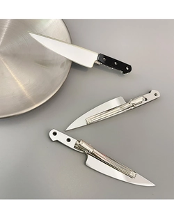Detail showing the realistic silver metal chef knife hair clips with secure metal duckbill grips