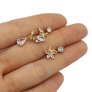 Macro detail of gold nose stud chain with heart-shaped zircon and butterfly charms