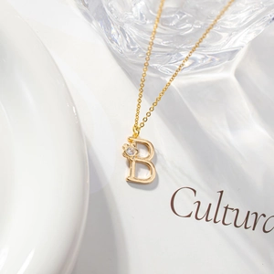 Minimalist gold letter B necklace with cubic zirconia flower on elegant chain