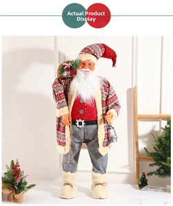 Detailed view of standing Santa Claus figure with gift bag and lantern in festive decor