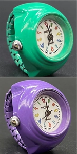Detailed macro view of colorful cartoon quartz watches in green and purple colors