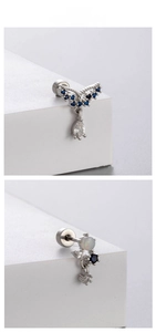 Dettaglio macro di orecchini con ali di fiori in zircone blu e vite in acciaio
