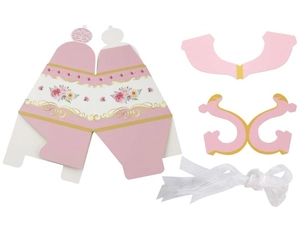 Flat lay of pink floral teapot candy box components with elegant white silk ribbon details