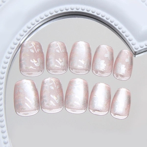 Cat eye press-on nails with sweet pink floral patterns and silver glitter finish