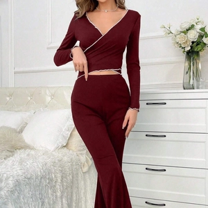 Women's burgundy knit lounge set with V-neck wrap top and high-waisted flared trousers