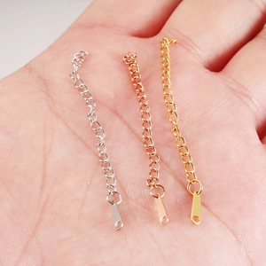 Three 6.5cm stainless steel extender chains in silver, rose gold, and gold on a palm