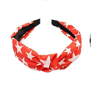 Independence Day red knotted headband with white star pattern on plain background