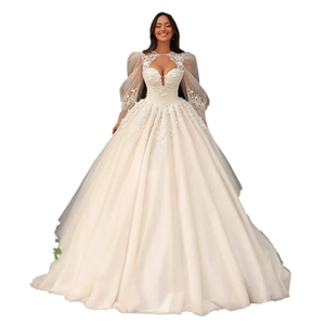 Elegant ivory ball gown wedding dress with lace bodice, high neck, and sheer lantern sleeves