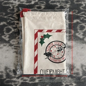 Close-up of North Pole Express Delivery canvas Christmas drawstring gift bag 38x28cm