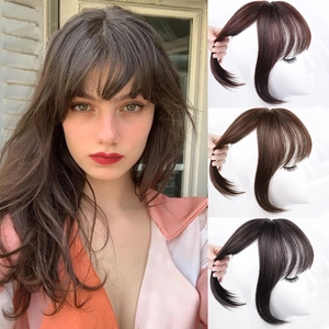 Detailed close-up of 3D hair fringe extensions in dark brown, light brown, and natural black