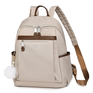 Beige and brown travel backpack with side pockets and a white plush pearl charm