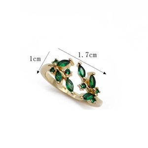 Detail shot of gold copper ring with green marquise zircon leaves and dimension marks