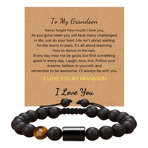 Detail of matte black onyx bracelet with tiger eye bead on gift card for grandson