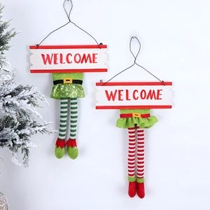 Detail of Christmas elf welcome signs with striped legs and sequined skirts decor