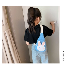 Back view of a child wearing a blue canvas rabbit chest bag with white woven strap