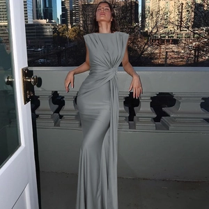 Detail of grey sleeveless maxi dress featuring a twisted waist and elegant draping effect