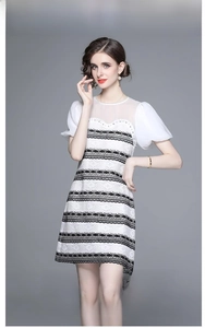 Detail of French vintage dress featuring black and white lace with beaded mesh neckline
