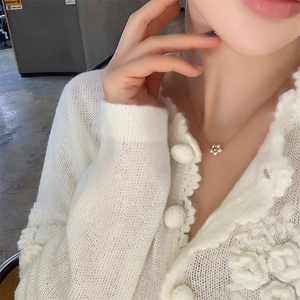 Chic 18K gold plated daisy flower pearl necklace shown on model with knit cardigan