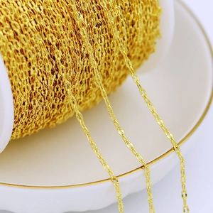 Macro shot of 18K gold plated copper O-chain with delicate flat links on a large spool
