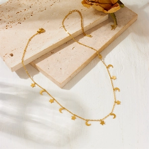 Elegant gold plated stainless steel moon and star charm necklace on stone