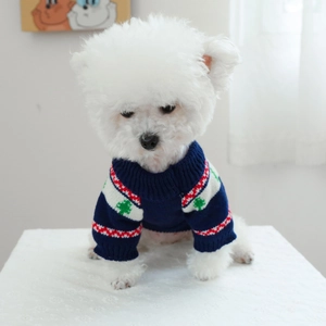 Close-up of navy blue pet knit sweater with festive forest patterns on a dog