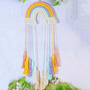 Detailed view of handmade macaron rainbow wall hanging with soft cotton fringes