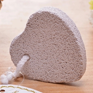 Detail of heart-shaped volcanic pumice stone with porous texture and hanging cotton rope