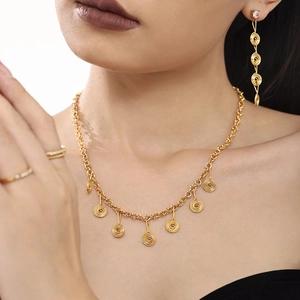 Golden stainless steel jewelry set featuring spiral pendant necklace and matching earrings