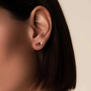 Detail shot of long rectangular rainbow zircon earrings worn on the earlobe