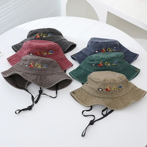 Detail of colorful kids cotton bucket hats featuring cute vehicle embroidery and wind ropes