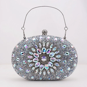 Close-up of floral crystal pattern on silver rhinestone evening clutch bag with top handle
