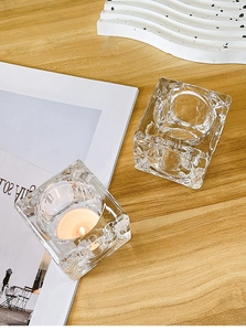 Detailed view of square ice-cube crystal glass candle holder on wooden table