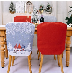 Detail of Christmas gnome chair cover featuring white snowflakes and pine forest patterns