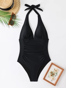 Flat lay of black halter monokini with deep V-neck and ruched tummy control detail
