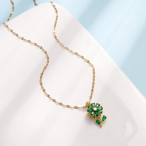 Golden titanium steel necklace featuring a rotating green zircon flower pendant