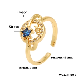 Detailed view of adjustable star and planet ring in gold copper with blue zircon