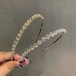 Delicate gold metal headband for women with shimmering round crystals and a slim design